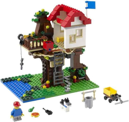 Built brick treehouse on two trunks with ladder and red bucket trap