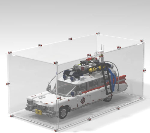Clear display case with brick-built base holding a white vintage ambulance car model