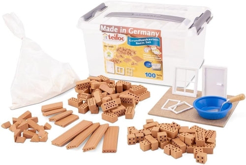 Small real clay bricks and mortar assembled into a miniature house