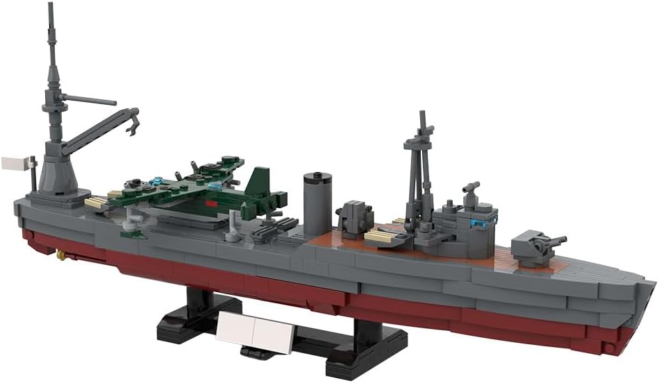 Gray brick-built aircraft carrier with flight deck and island tower