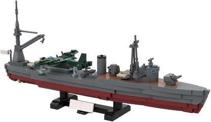 Gray brick-built aircraft carrier with flight deck and island tower