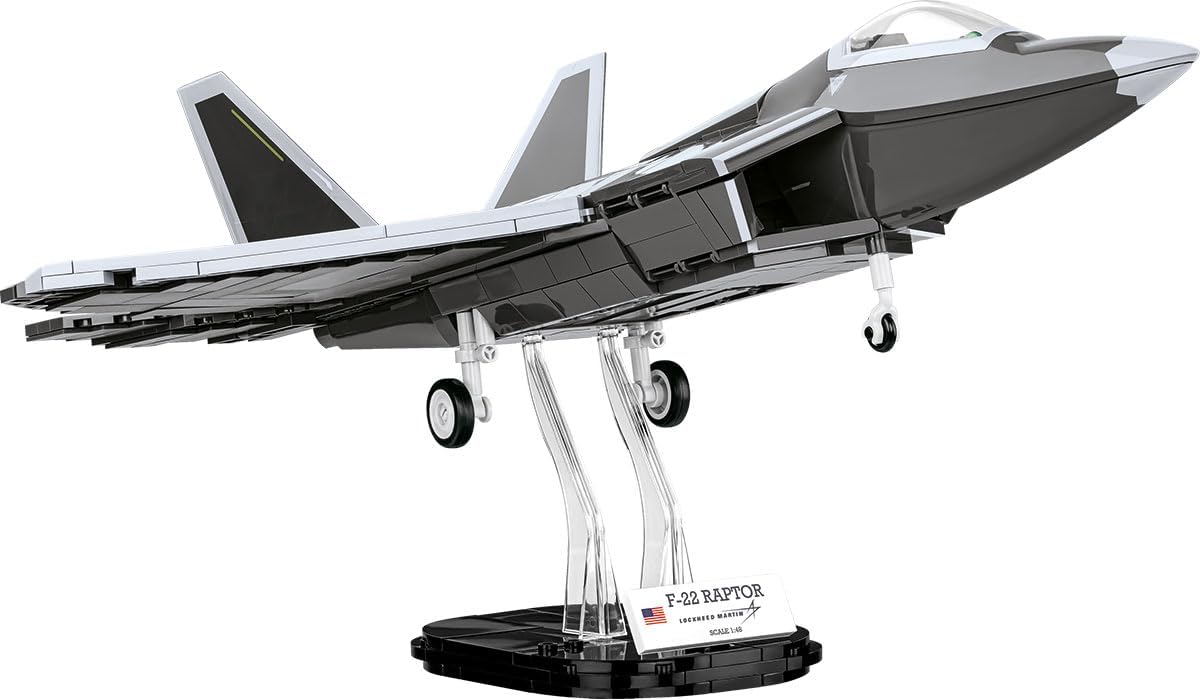Black and white stealth fighter jet brick model on a display stand