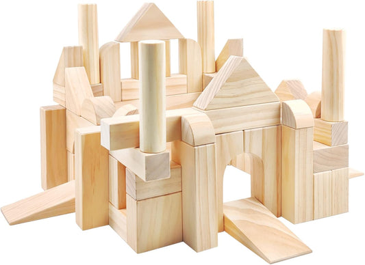 Natural wooden building blocks in arches, cubes and cylinders stacked beside a wooden box