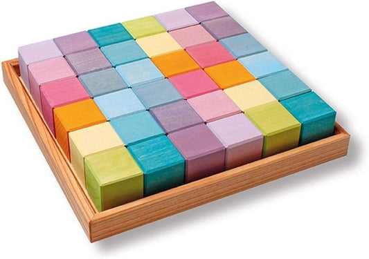 Pastel colored wooden square blocks arranged in a wooden frame