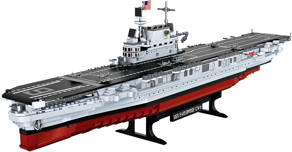 Brick-built grey WWII aircraft carrier with long flight deck and island tower