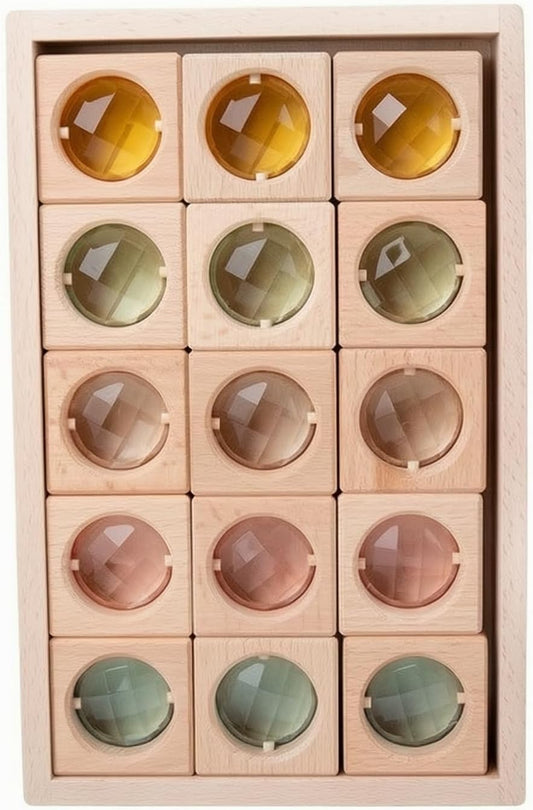Fifteen wooden blocks with rainbow acrylic gem inserts arranged in a wooden tray