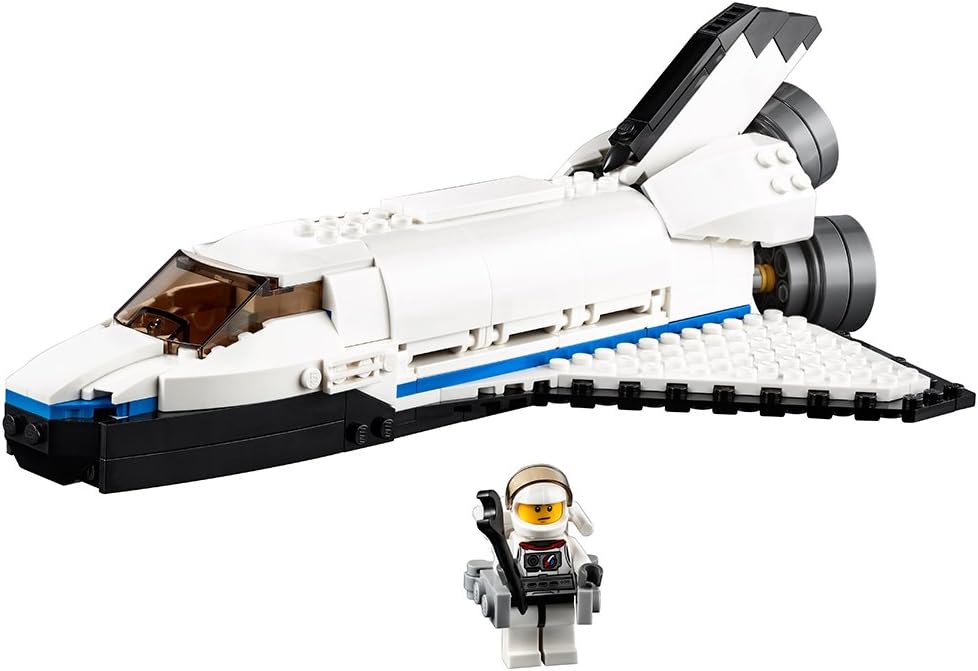 Brick-built white space shuttle with robotic arm and astronaut figure
