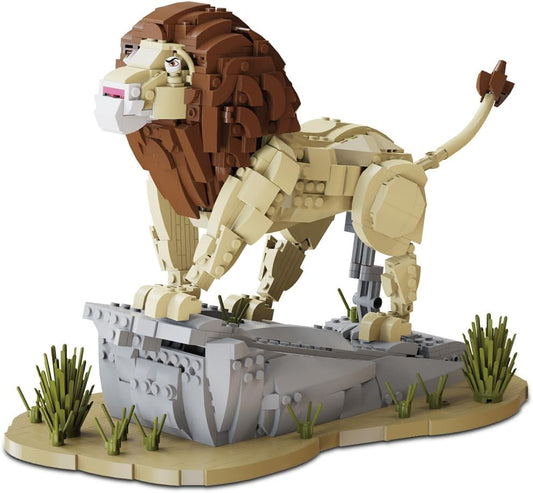 Brick-built adult lion with full mane standing on a rocky savanna outcrop