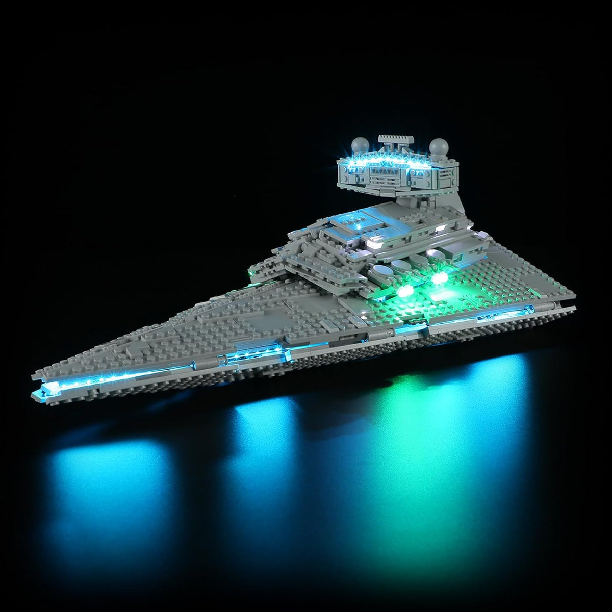Large wedge-shaped gray brick warship glowing with blue LED engine lights – view 2