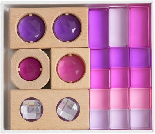 Translucent purple acrylic blocks and wooden pieces with round lenses stacked into a structure