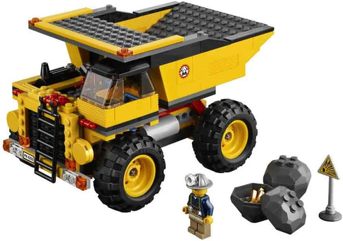 Brick-built yellow mining truck with large wheels and a rock with gold nuggets