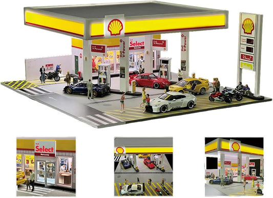 Miniature 1:64 scale gas station diorama with canopy, fuel pumps and small accessories