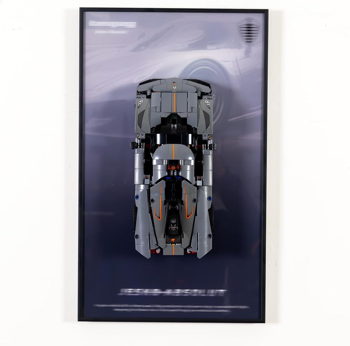 Wall-mounted display frame holding a large brick supercar model – view 2
