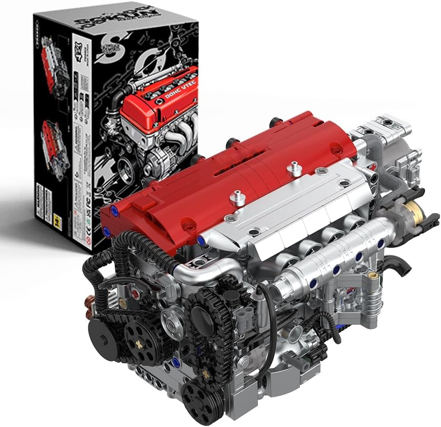 Silver brick-built four-cylinder engine with red valve cover and yellow pistons