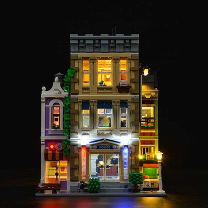 Police station brick model glowing with installed LED lights at night – view 2