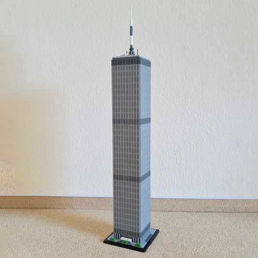 Tall brick model of the World Trade Center tower on a base