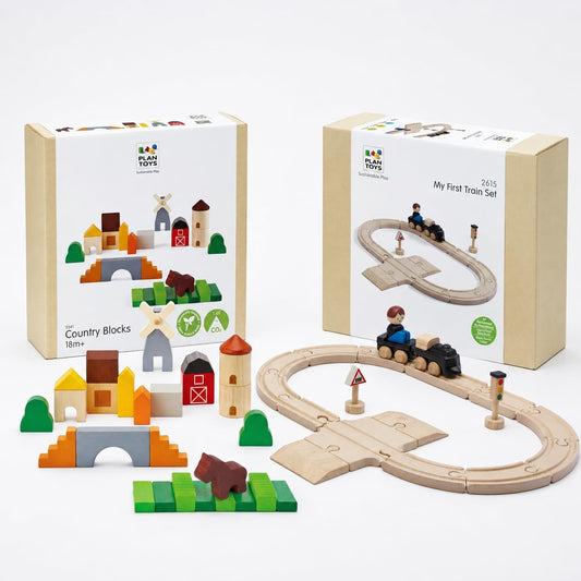 Wooden train on rail and road track beside stacked wooden village blocks