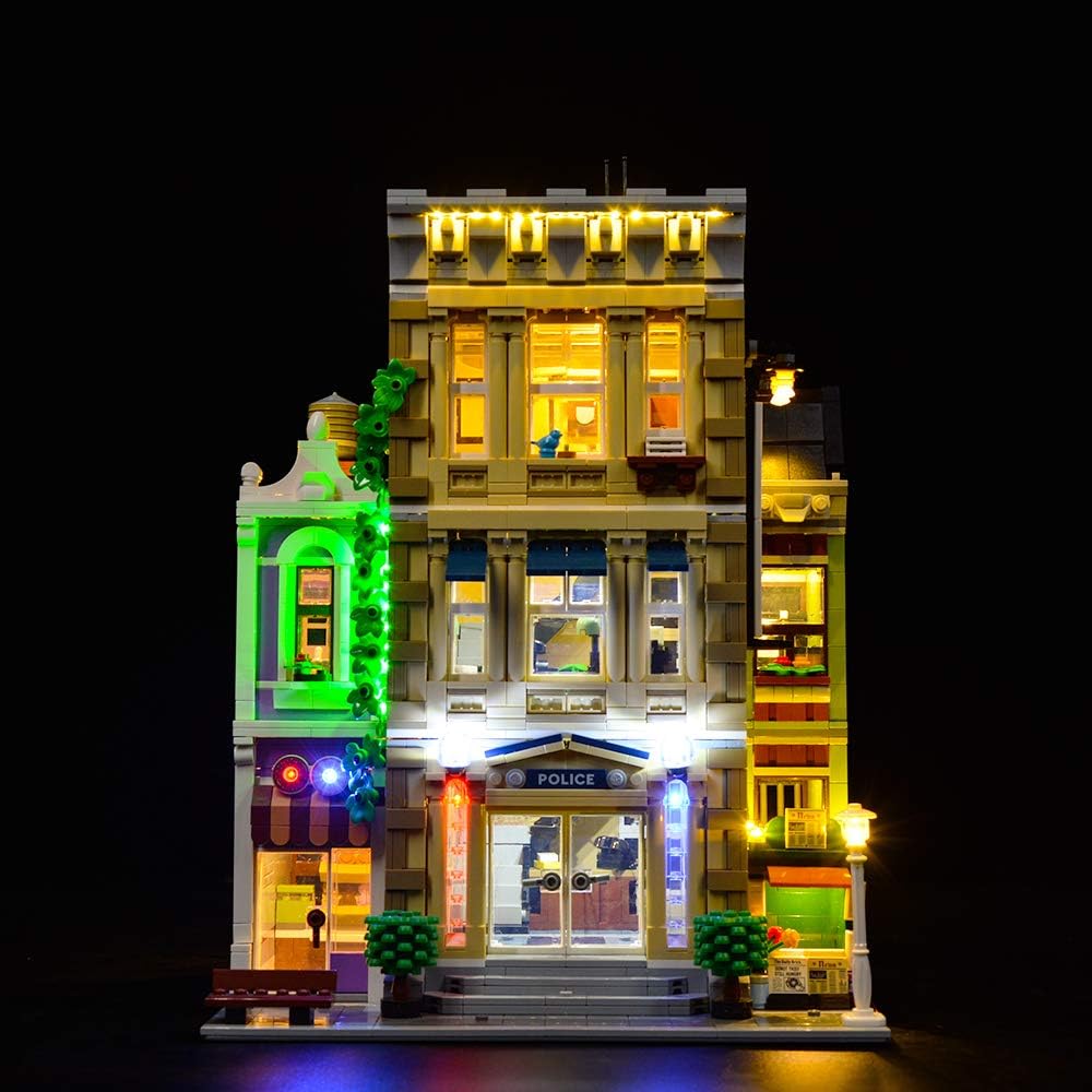 Police station brick model glowing with installed LED lights at night – view 3