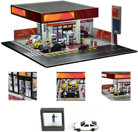 Miniature 1:64 gas station diorama with lit signage, fuel pumps, car wash bays and a small car