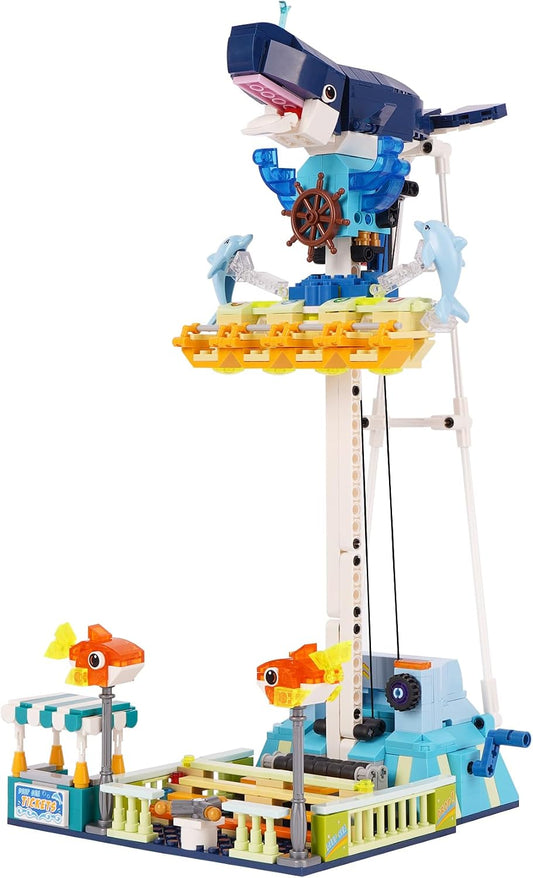 Brick-built amusement park drop tower with a large black shark head at the top