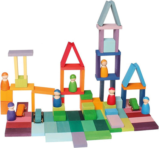 Rainbow row of stained wooden domino blocks standing in a curved rally line