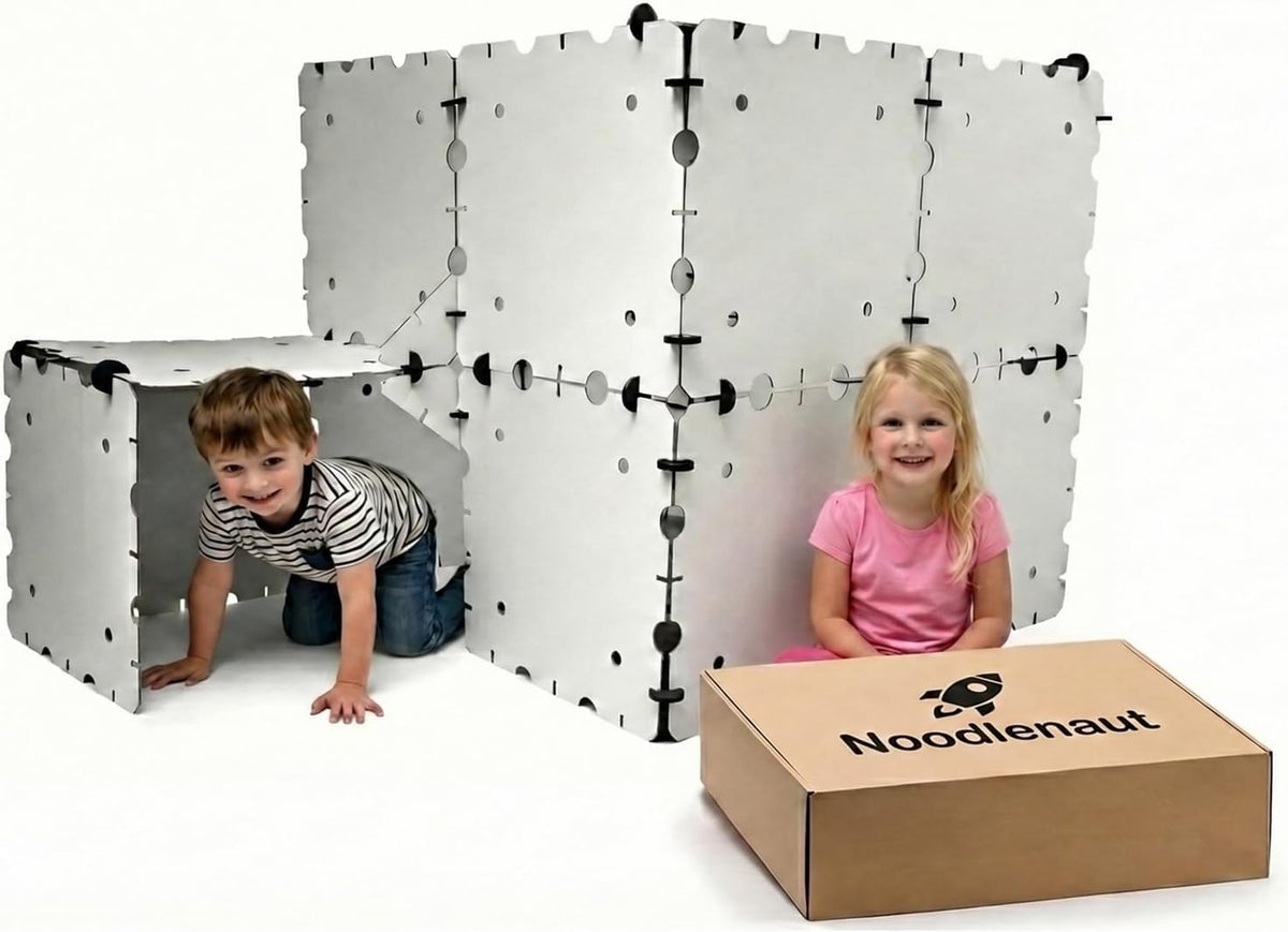 White cardboard panel fort built into a castle with a tunnel