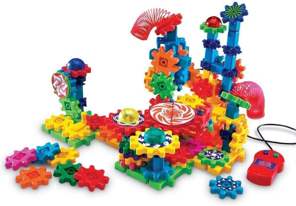 Colorful interlocking plastic gears on a motorized base with flashing lights