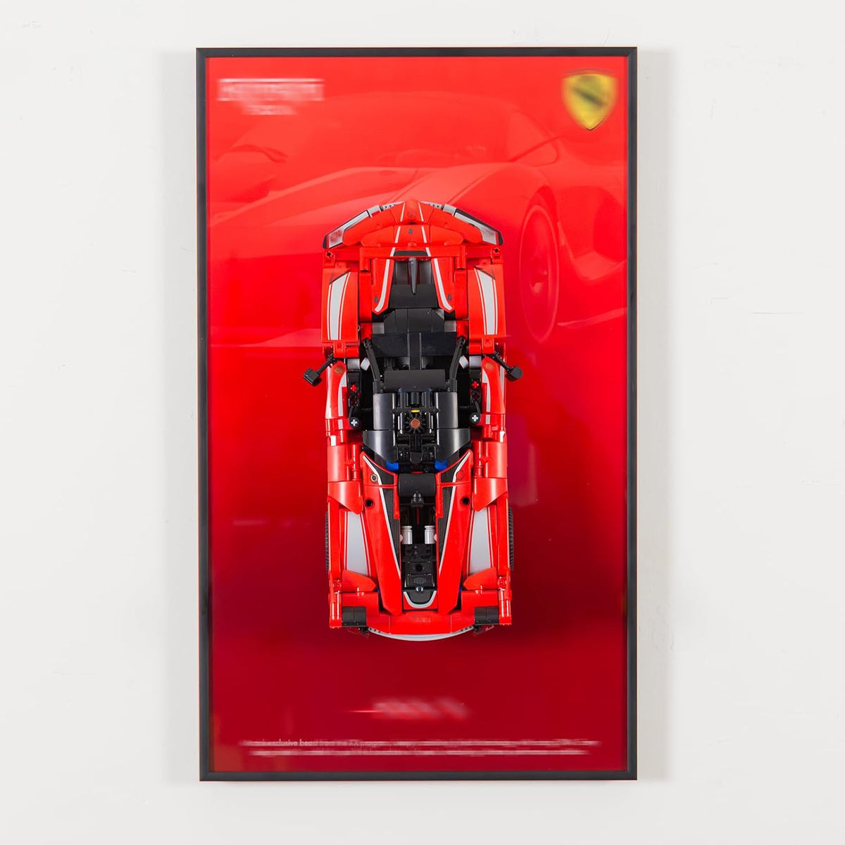 Wall-mounted display frame holding a large brick supercar model
