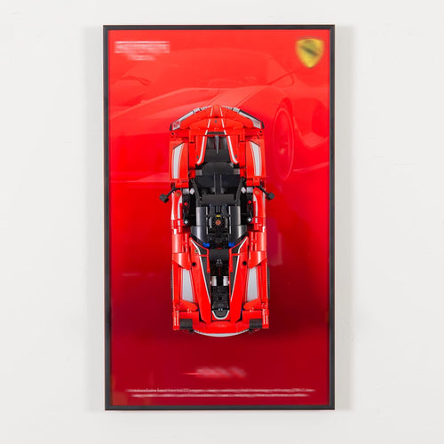 Wall-mounted display frame holding a large brick supercar model