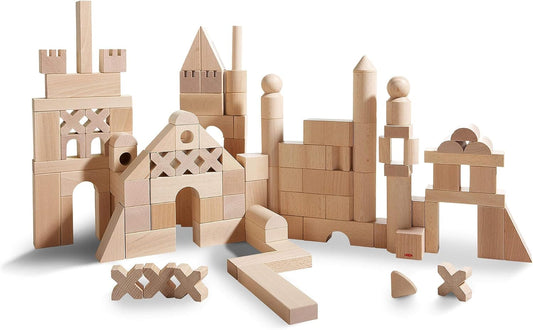 Natural wooden building blocks in assorted shapes stacked into a small tower