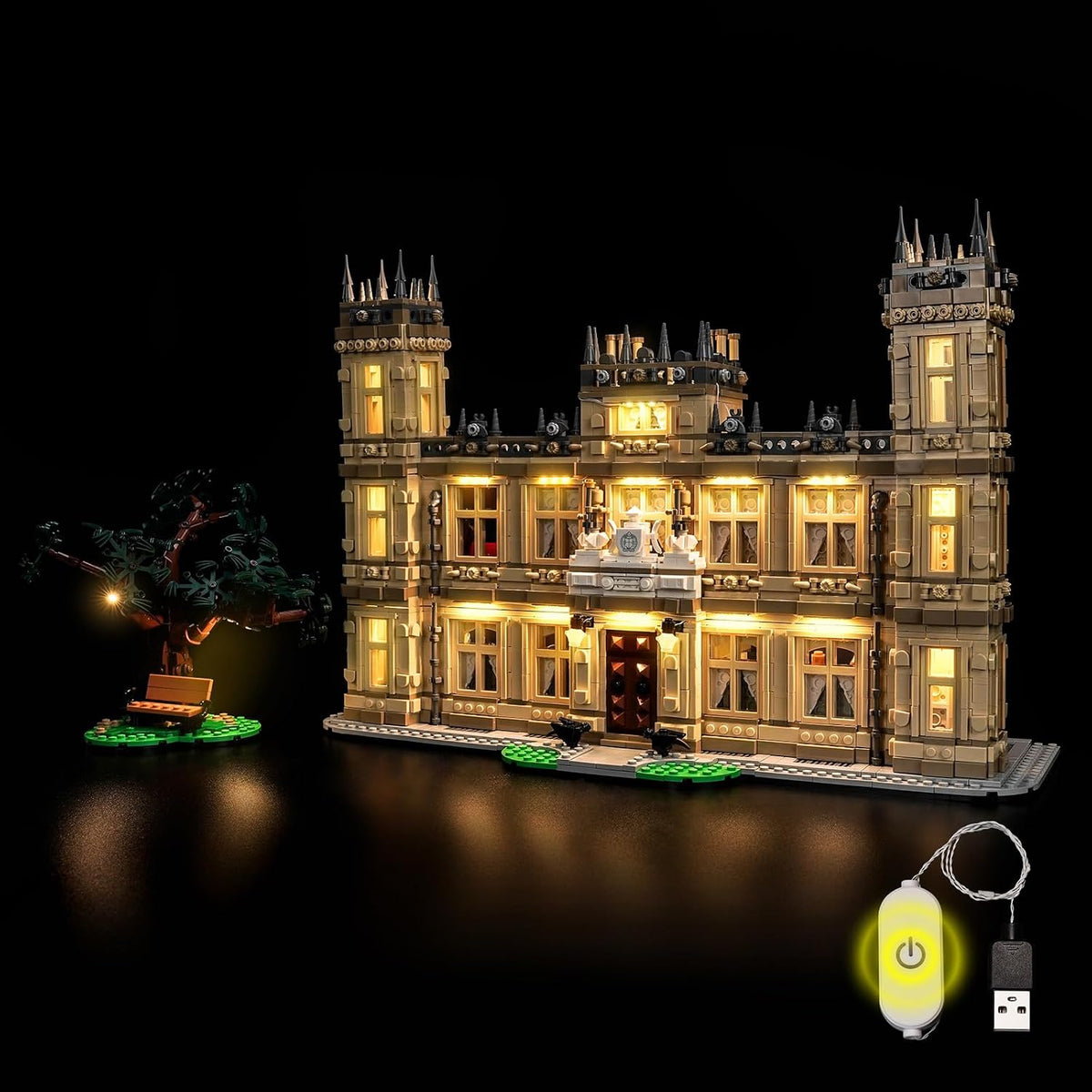 English country manor house brick model glowing with warm window lights at night