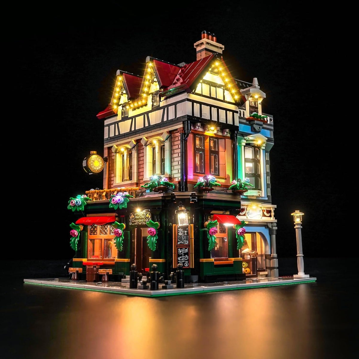 Tudor-style half-timbered street corner brick model glowing with LED window lights – view 2