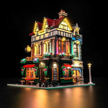 Tudor-style half-timbered street corner brick model glowing with LED window lights – view 2