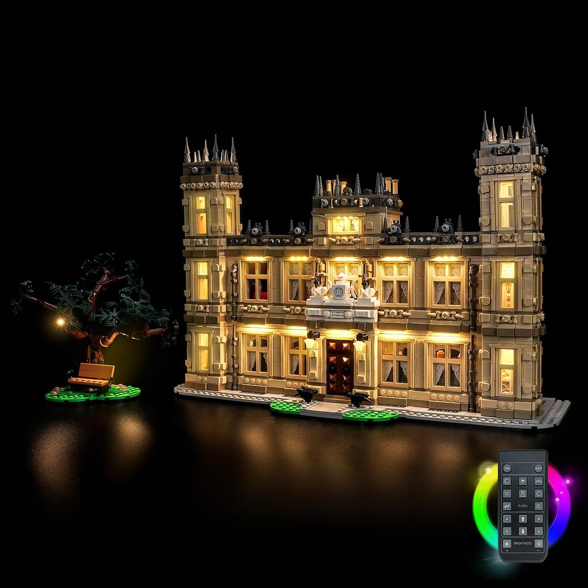 English country manor house brick model glowing with warm window lights at night – view 2