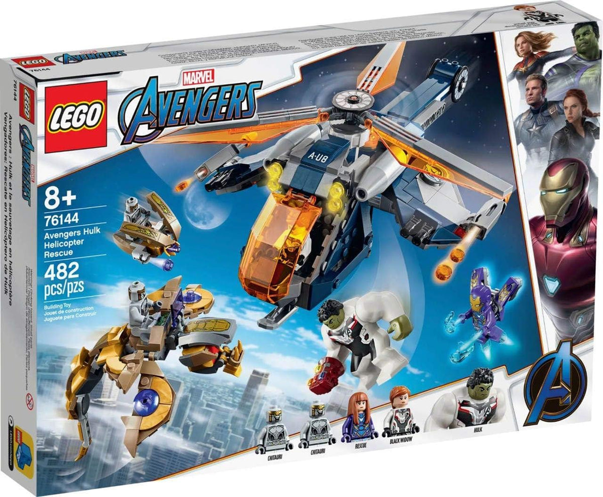 Brick-built rescue helicopter dropping a large green hero figure above an alien creature