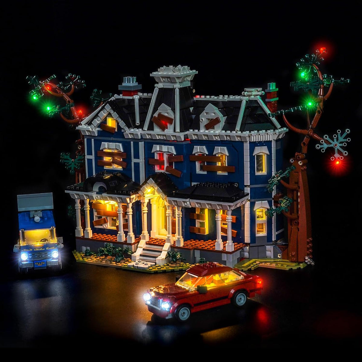 Haunted Victorian house brick model lit with eerie LED lights in a dark room – view 2