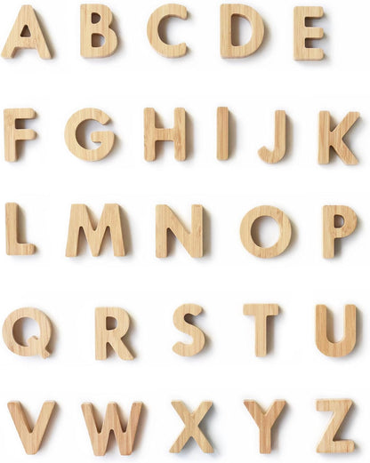 Bamboo alphabet blocks with printed letters stacked in a row