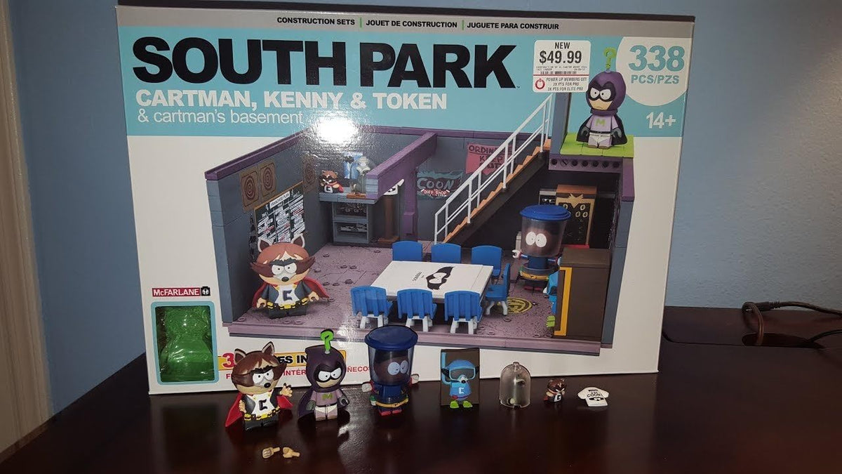 Brick-built cartoon basement superhero headquarters with three figures