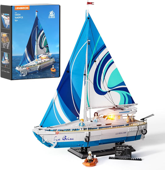 Brick-built sailing yacht with white sails and glowing lights on a display base