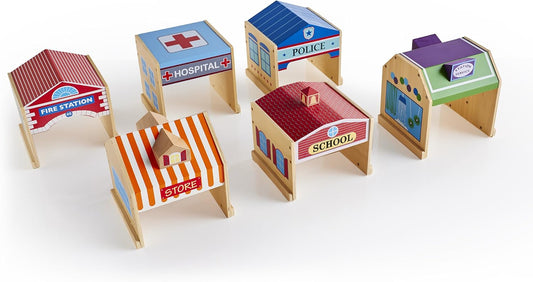 Six colorful wooden play buildings including a fire station, hospital and school