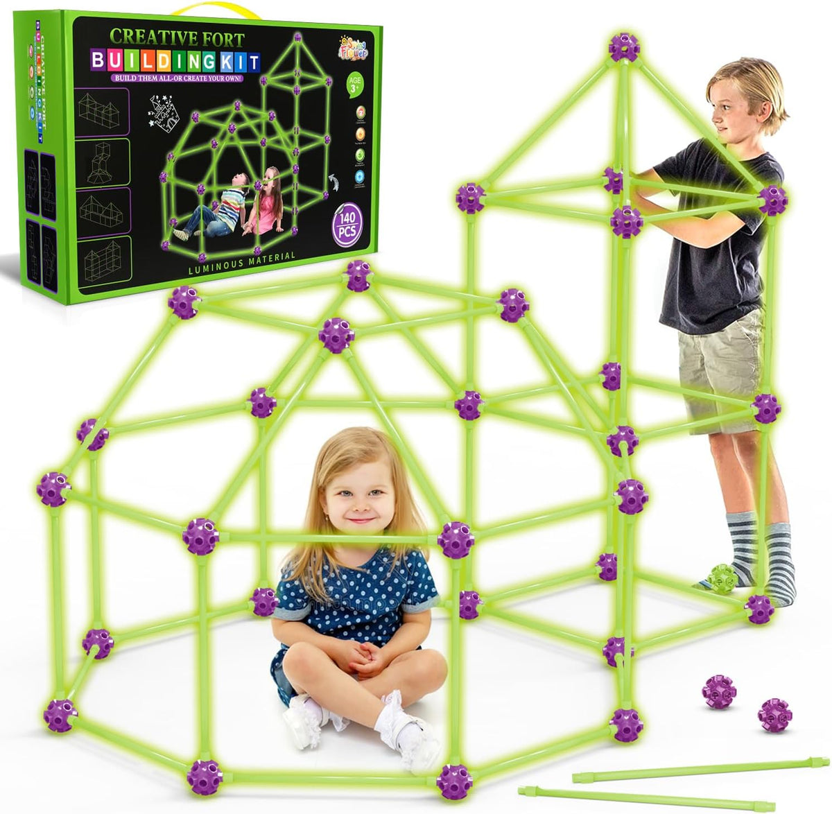 Child-sized fort made of rods and connector balls glowing green in a dark room
