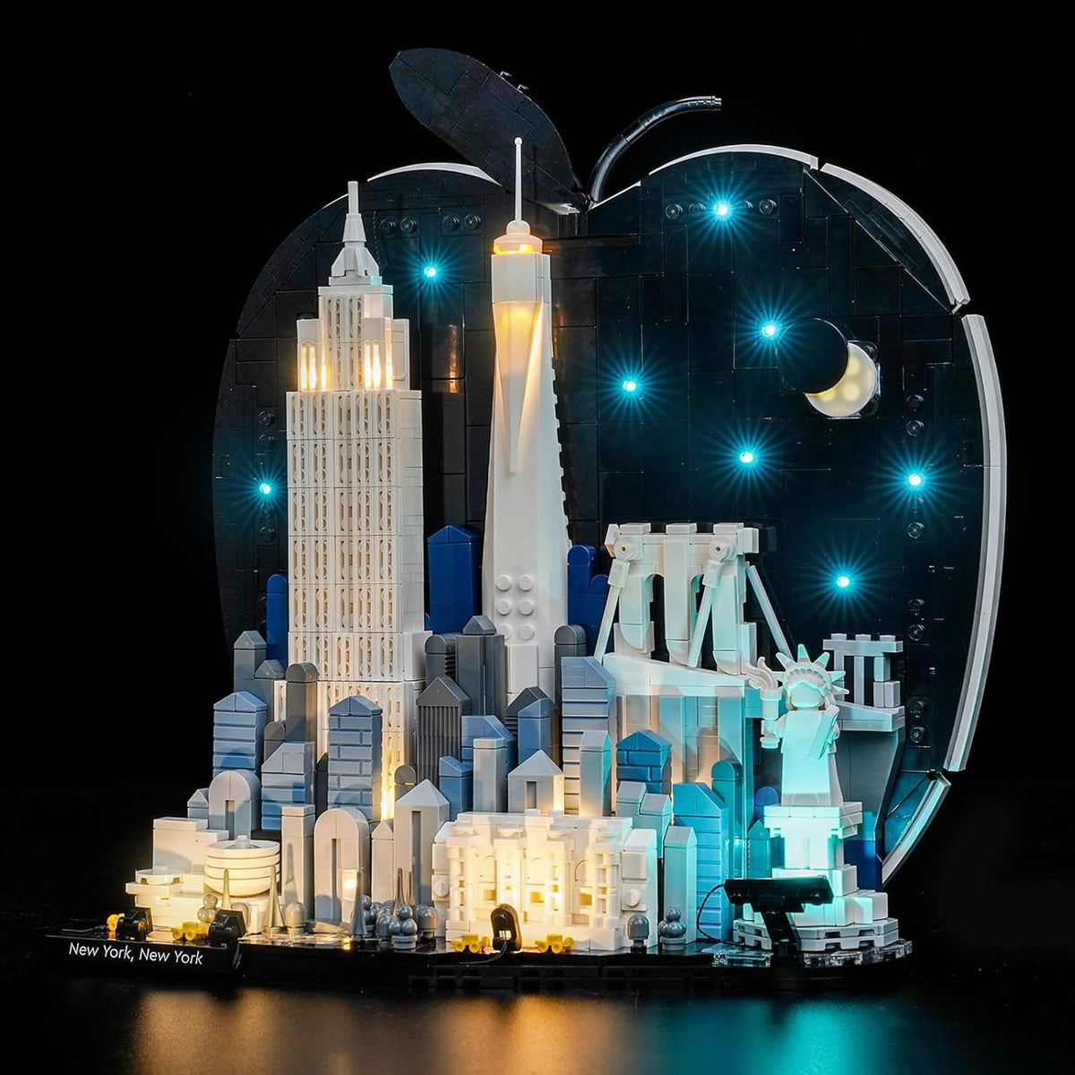 Brick-built New York skyline model glowing with warm LED lights in its towers – view 2