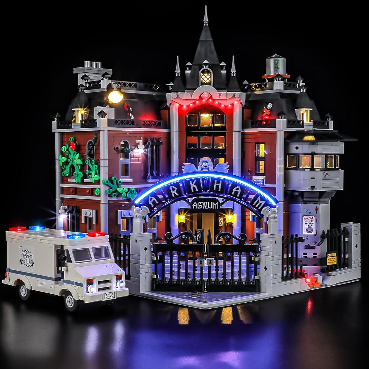 Brick-built gothic asylum building lit from inside by LED lights