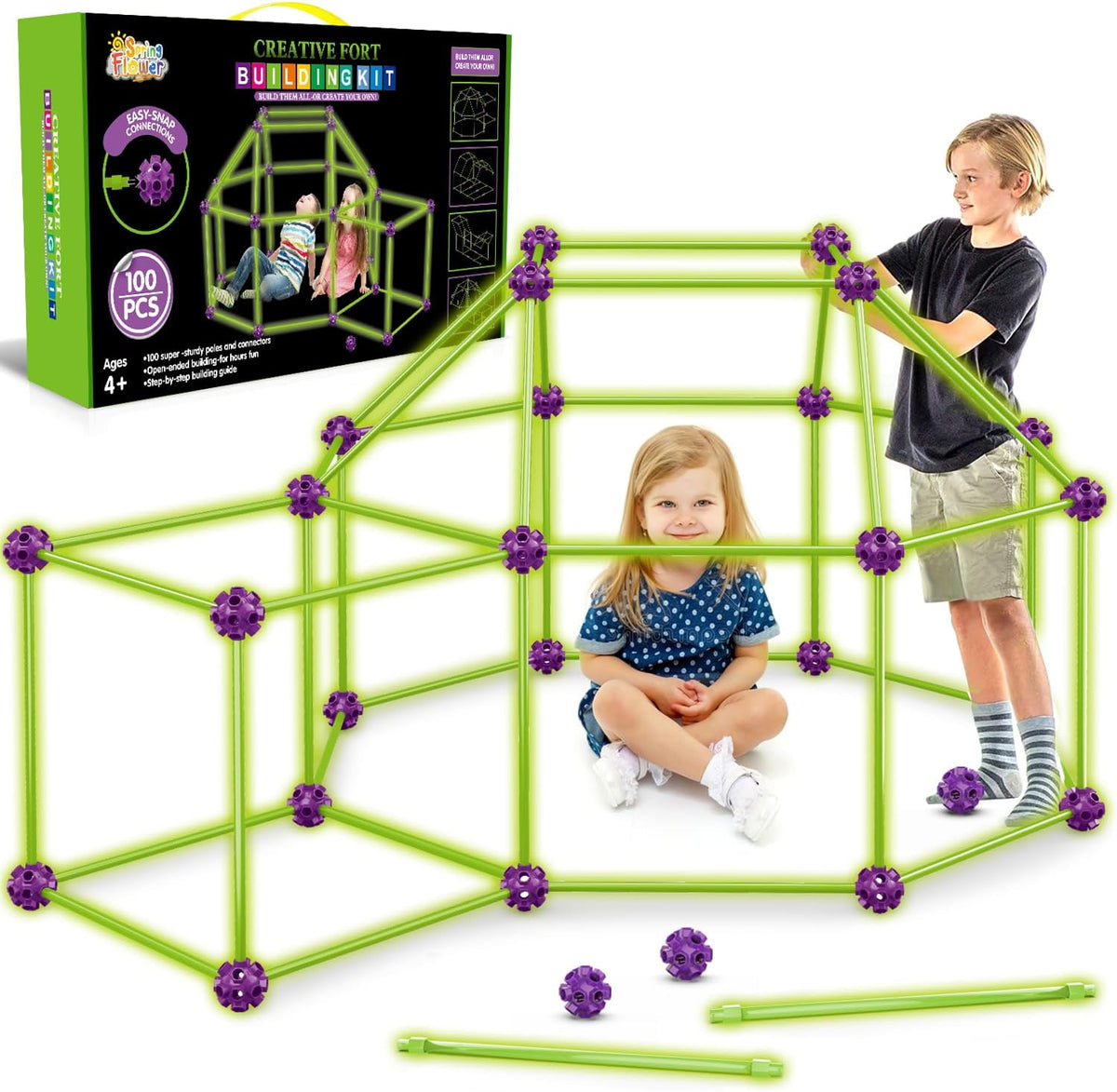 Child-sized fort made of rods and connector balls glowing green in a dark room – view 11