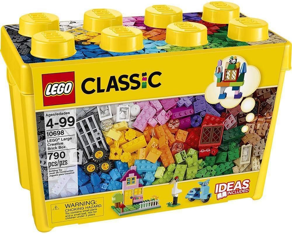 Assorted colorful bricks, windows, doors and wheels spilling from a large storage box