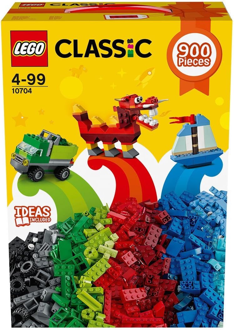 Assorted colorful building bricks spilling from a storage box beside small models