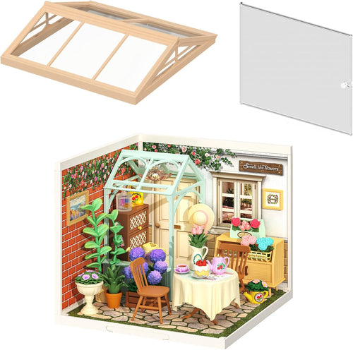 Miniature tea garden diorama with tea table, potted flowers and warm LED glow
