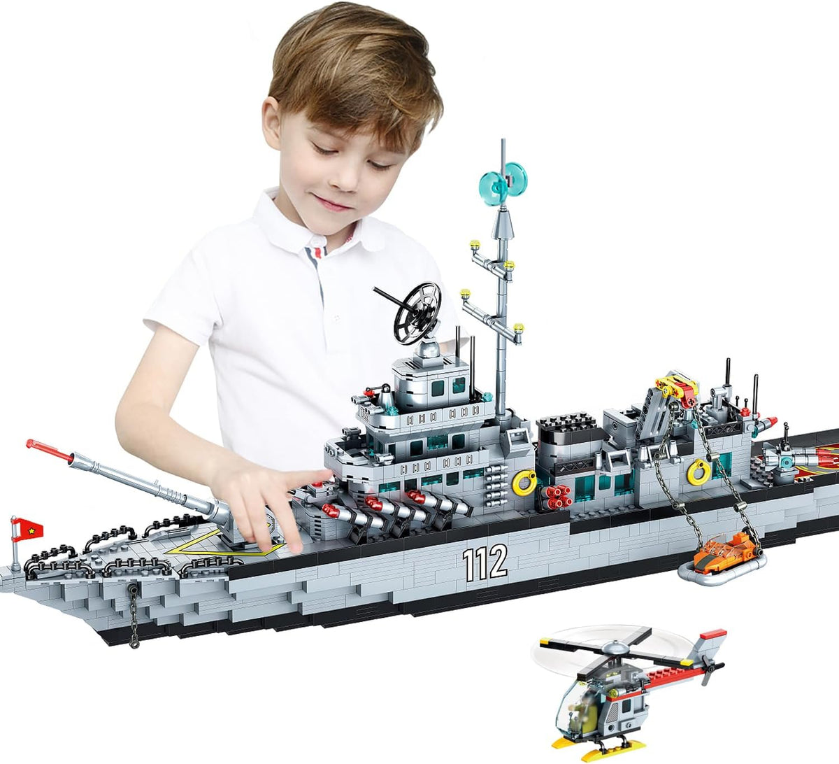 Long brick-built gray WWII navy battleship with gun turrets and helicopter on deck – view 2