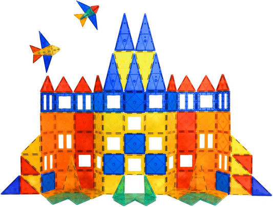 Colorful magnetic tiles built into a castle and a rocket beside a storage bag
