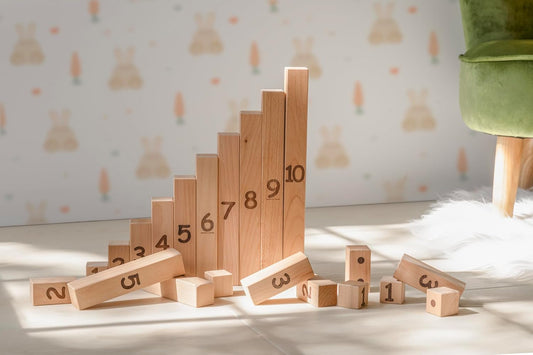 Wooden number blocks with engraved numerals and dots beside flashcards